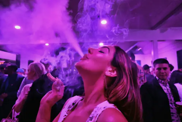 This photo a guest takes a puff from a marijuana cigarette at the Sensi Magazine party celebrating the 420 holiday in the Bel Air section of Los Angeles